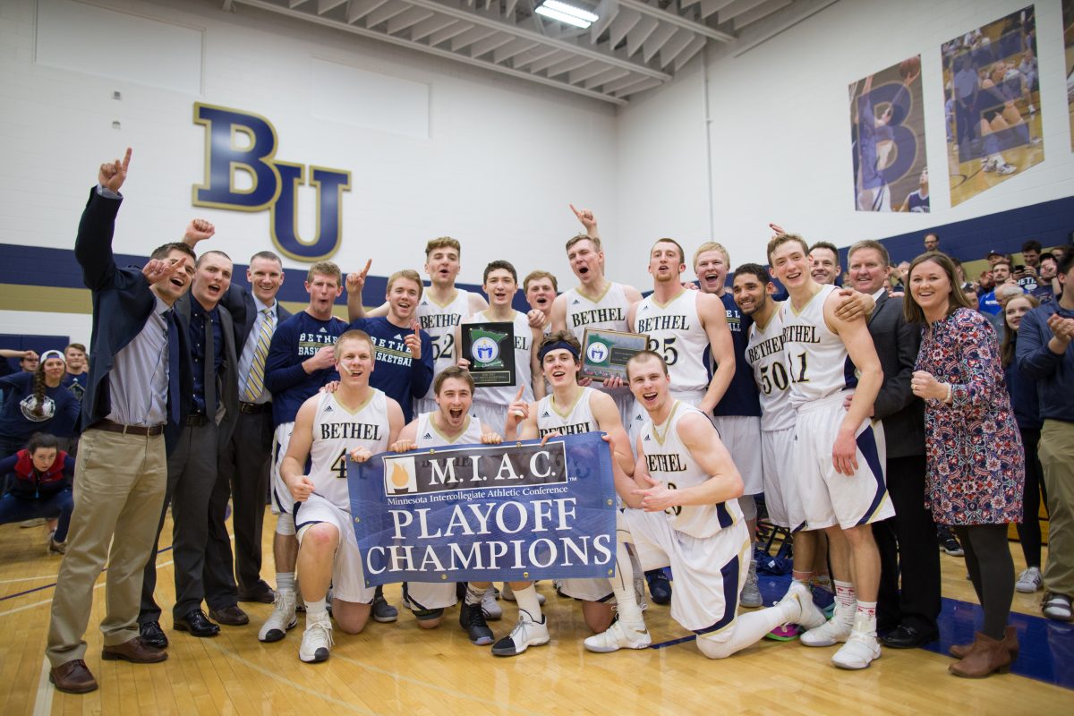 The Bethel Royals Basketball team poses for a picture with their 2017 MIAC Championships banner. This is the first time the Royals won the MIAC Playoff tournament since 1991. Photo by | Nathan Klok