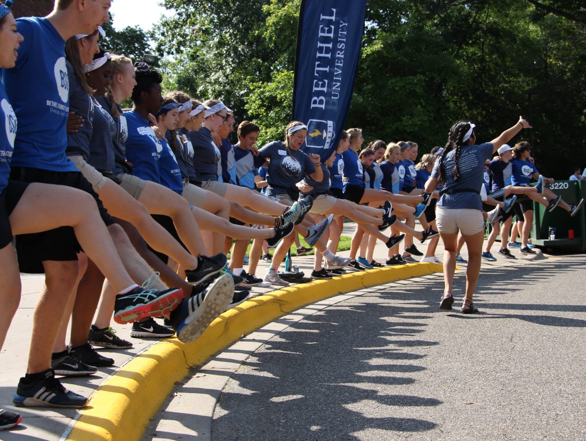 A crew of Welcome Week staffers form a kickline as they wait for more freshman to arrive. The Welcome Week crew danced, sang and cheered their way through move in day. | Photo by Josh Towner