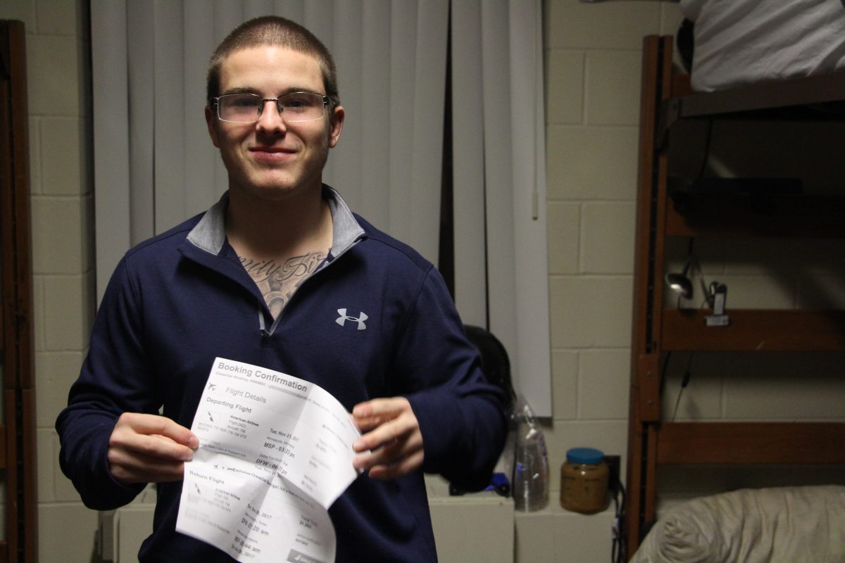 First-year+Bethel+student+Kyle+Sutton+holds+up+his+ticket+home+his+friends+and+70+others+bought+him+for+Thanksgiving.+%7C+Photo+by+Maddie+Christy