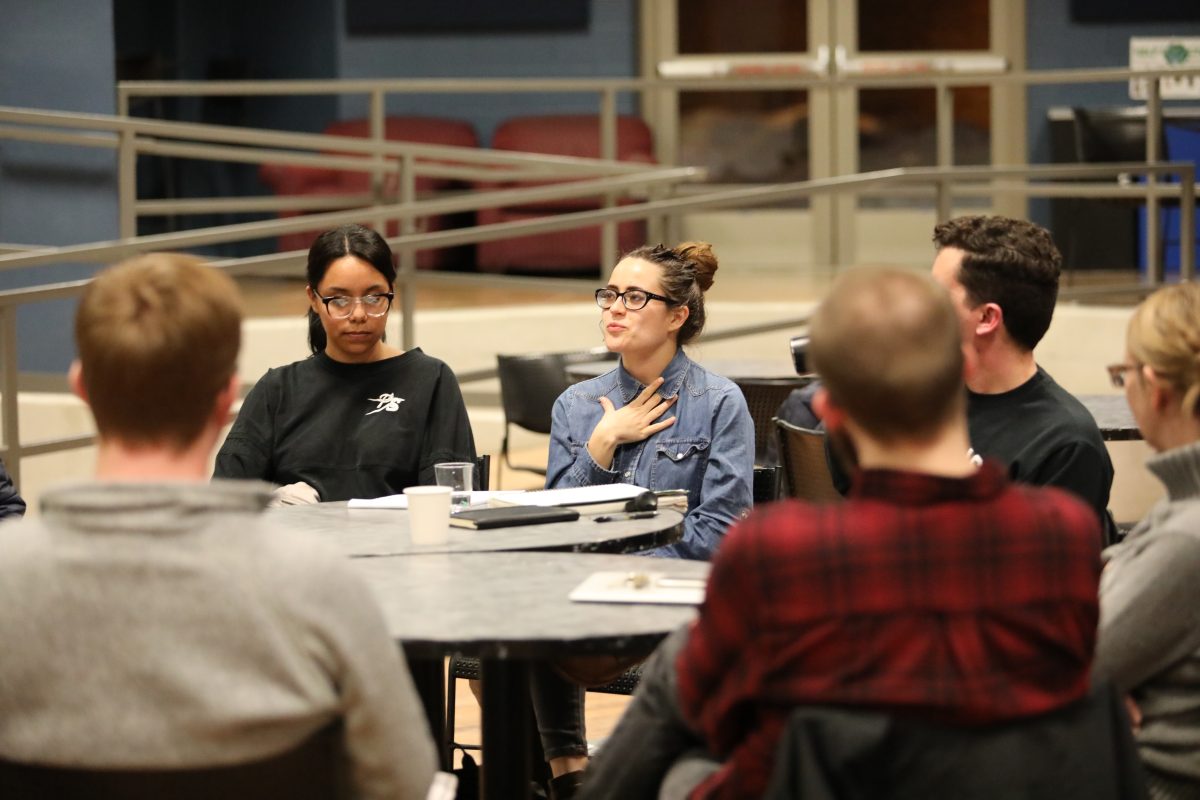 Bethel University members gather around a few tables to discuss the concept of socialism in the U.S. with DSA co-leaders Rita Allen and Nick Raymond. The group listened to Allen and Raymond share their passions for democracy, and participated in discussion about various socialist ideas afterward. “I believe that Christians should believe and experience what it truly means to love one another,” sophomore Caleb Quick said. Photo by Bri Shaw