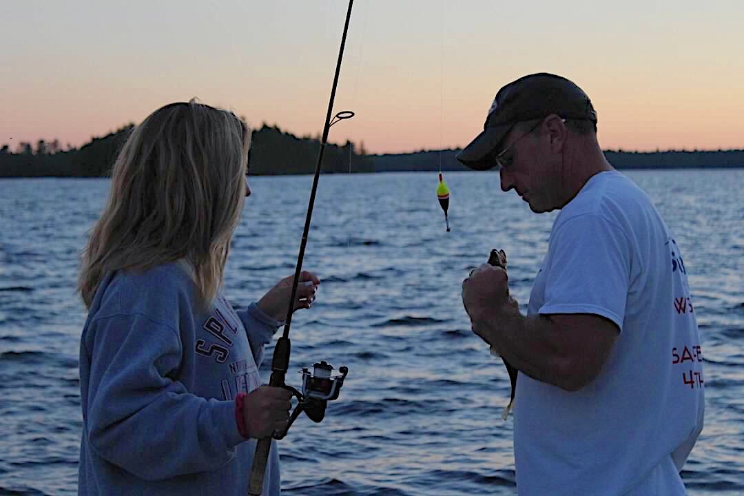Samantha Wurm and her dad Tony Wurm fish at dusk during an annual vacation up north in Ely, Minnesota during the summer of 2018.