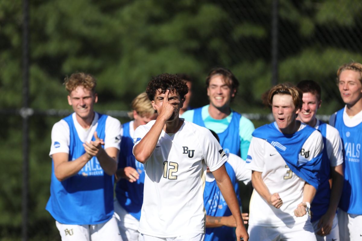 The Bethel University men’s soccer team celebrate together after freshman midfielder, Jack Gerber, scored the Royal’s fourth goal of the match against the University of Northwestern, Friday, August 30. The Royals took the first win of the season ending with a final score of 4-0. “The first game is always a little chaotic, a little crazy. Now we can calm down and exhale,” head coach Jeremy Iwaszkowiec said.