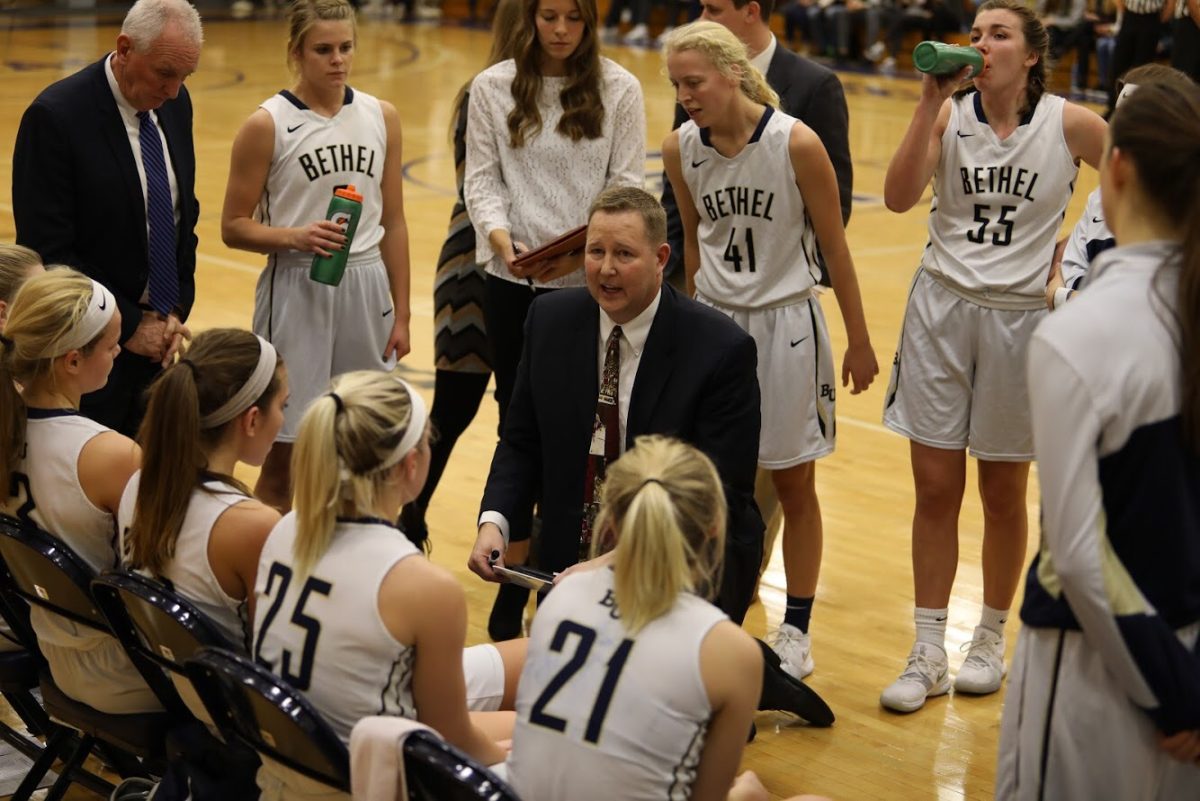 Coach Jon Herbrechtsmeyer consults his team during a timeout. | Photo by Ally O’Neil