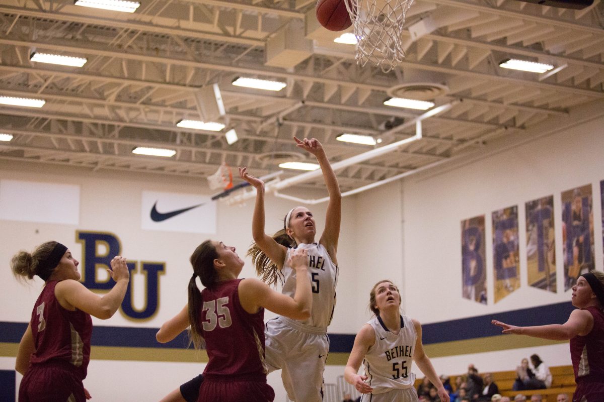 Senior Hannah Johnson fights through Hamline's Reilly Geistfeld for a contested layup. Johnson scored 18 points in the matchup. 