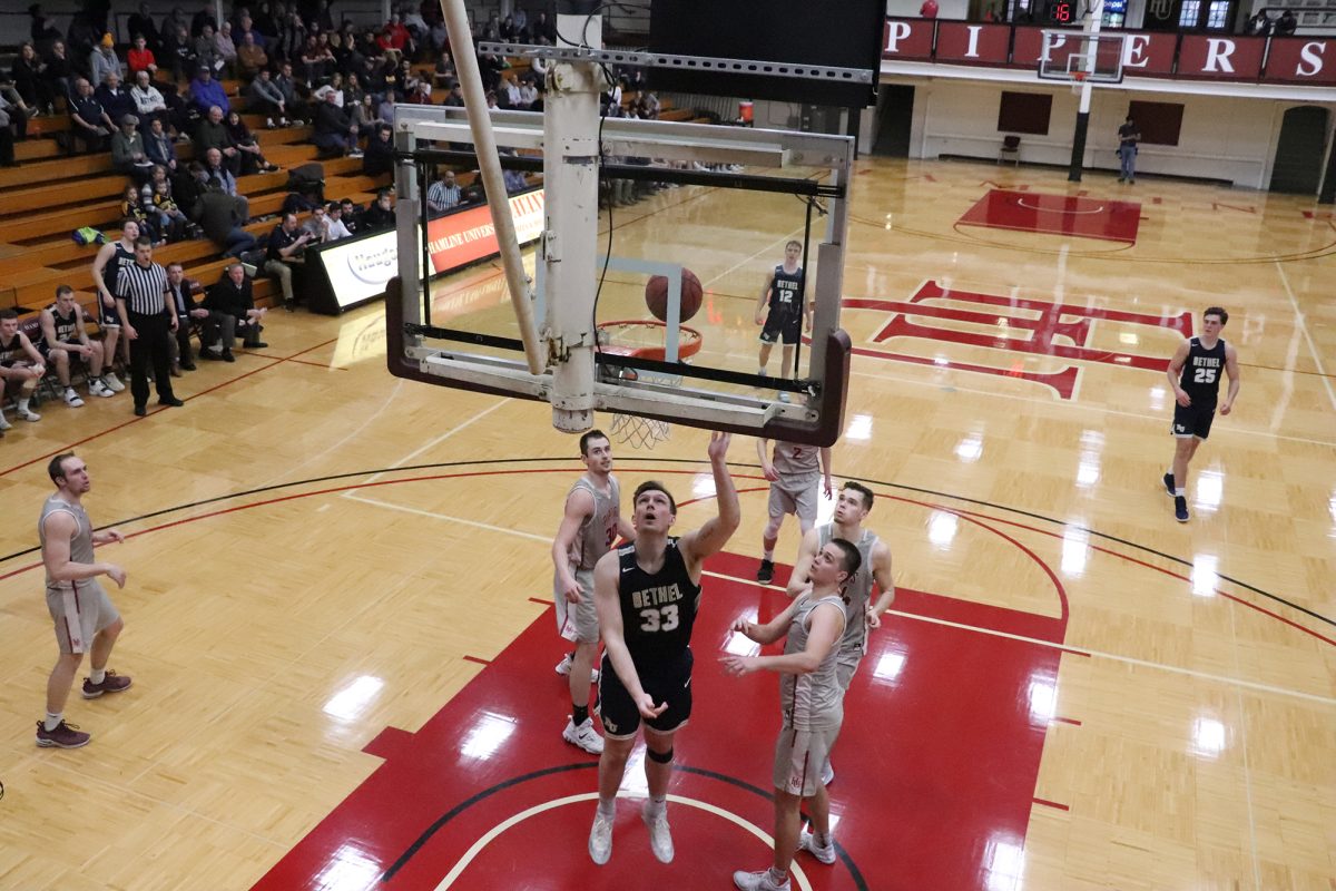 Derek Magnuson lays in a putback against Hamline Feb. 16. The Royals defeated the Pipers 89-63 in the final game of the regular season, clinching the third seed in the MIAC playoffs. | Photo by Sierra Smith