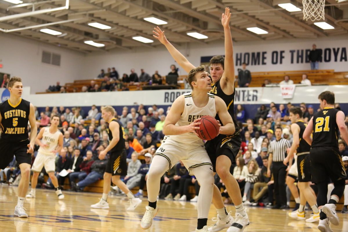 Senior center Derek Magnuson spins to score in the post against Gustavus Tuesday night. The Royals defeated the Gusties 93-67 to advance in the MIAC playoffs. | Photo by Katie Viesselman