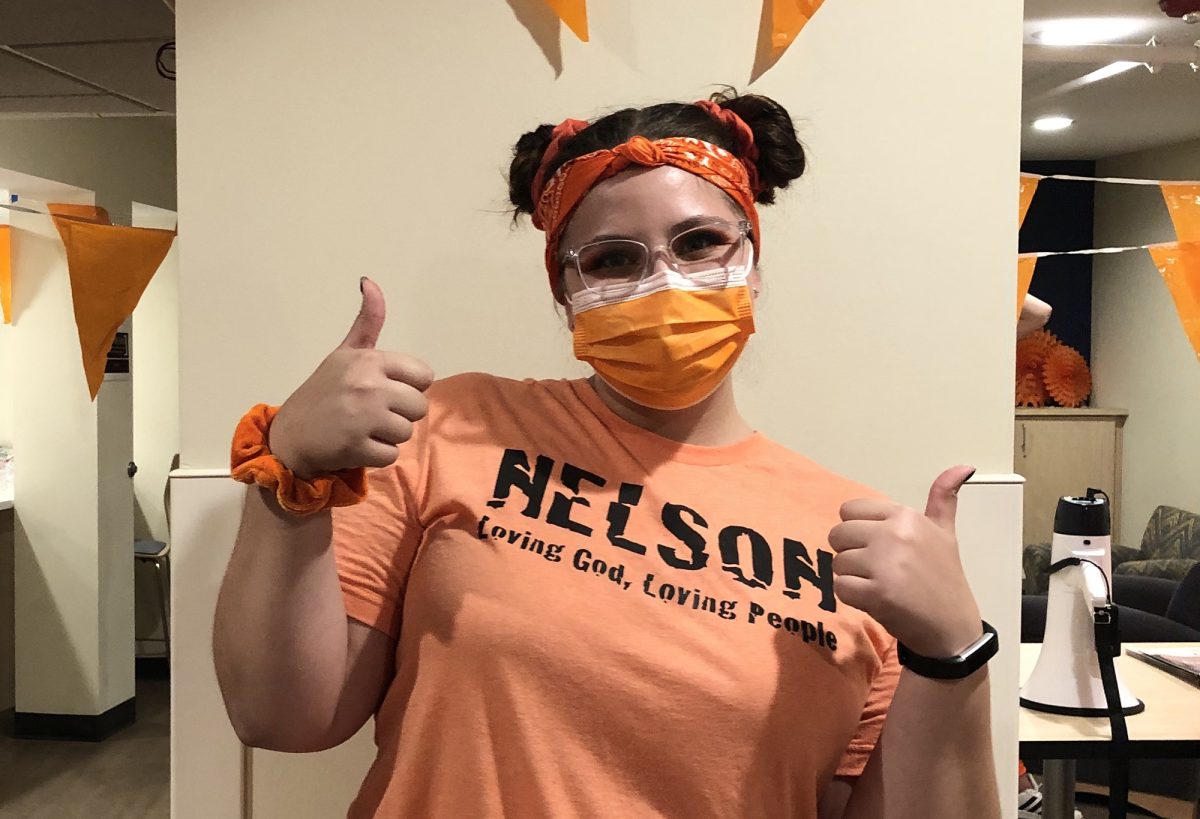 Kate Osgood wears her Nelson Hall orange to prep for cheer night Monday. | Photo by Soraya Keiser