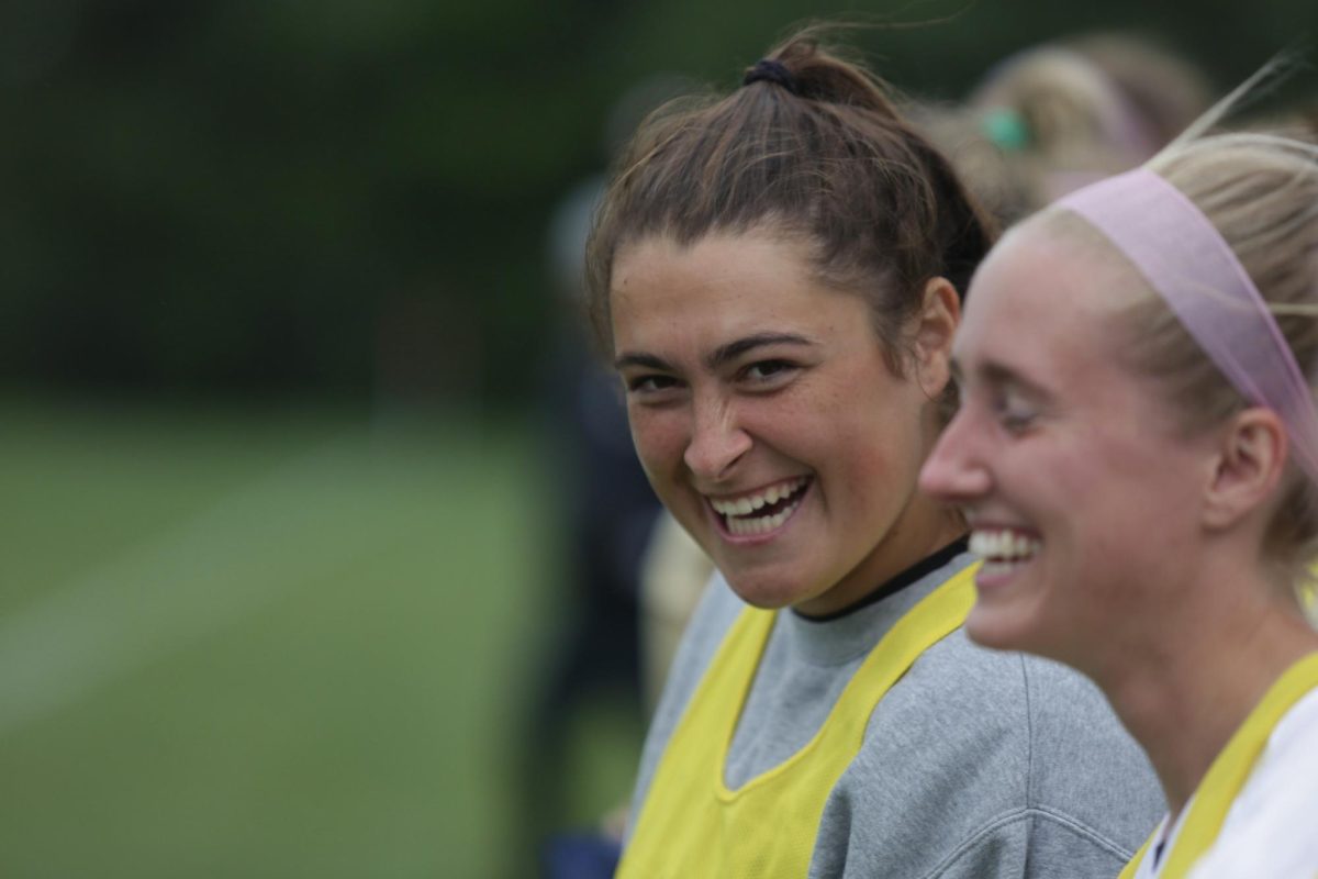 Senior soccer player Izzy Smith cheers her team on against Crown College from the sidelines Wednesday, Sept. 6. “I know it’s going to be hard to say goodbye. But with the team we have now, there’s already so much laughter, so much joy and so much freedom,” Smith said.