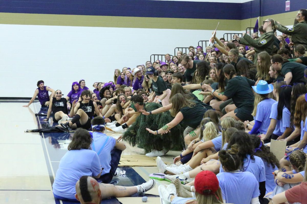 Bethel+students+watch+as+North+Village+performs+their+cheer+Monday.+The+Homecoming+captains+dressed+as+trees+and+some+students+wore+costumes+in+their+dorm%E2%80%99s+color+to+further+show+school+spirit.
