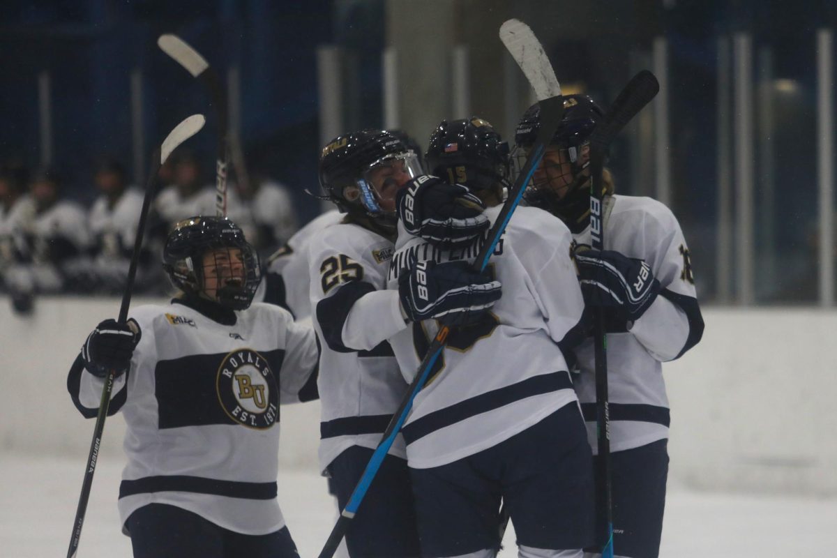 Lindsey Muntifering celebrates her third-period goal with teammates Sydney Eckert, Brynn Swenson and Ali Hoerer. Muntifering’s goal put the Royals up by two points, and they maintained their lead to win the game Saturday 3-1.