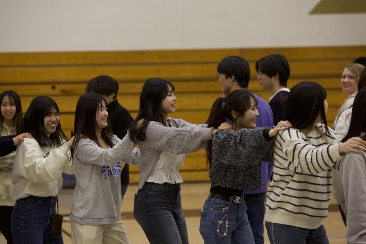 Kwansei Gakuin University student Airi Arima learns to square dance in the Robertson Center Gym, dancing the “horse and jockey” with four other Japanese students on the trip. 