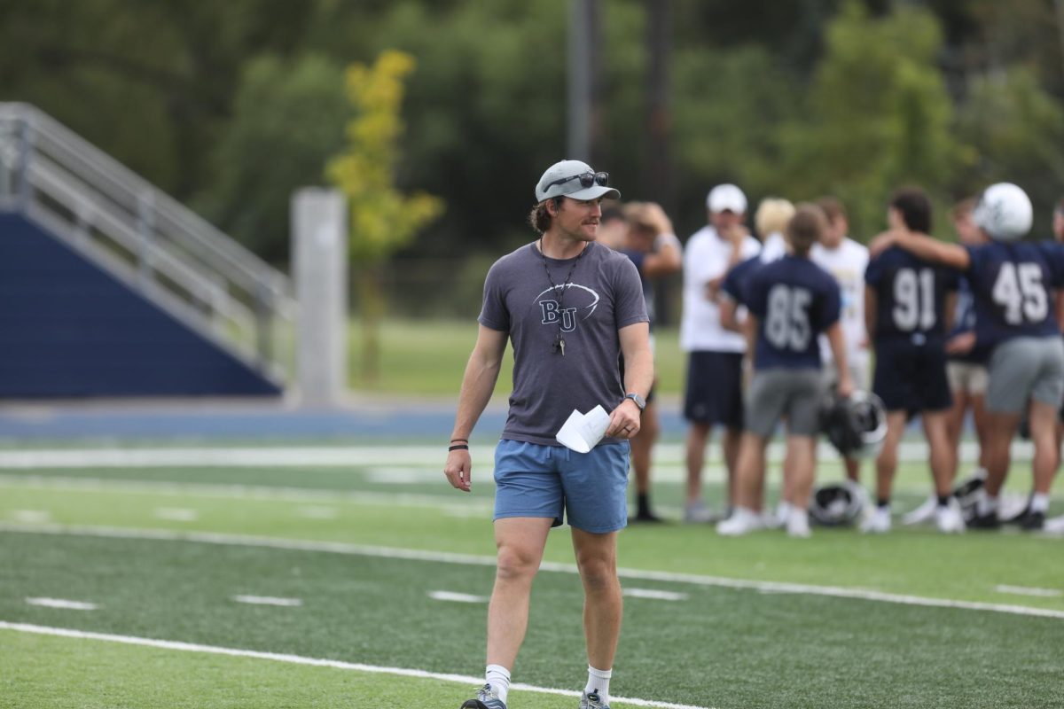 First-year Bethel head coach Mike McElroy walks through practice Tuesday afternoon ahead of Saturday evening’s season opener. McElroy took the head coach job in January after coordinating Bethel’s defense the past seven seasons and hopes to force opponents to spend ample time preparing to play Bethel. “We want to be expensive on offense and defense,” McElroy said. 