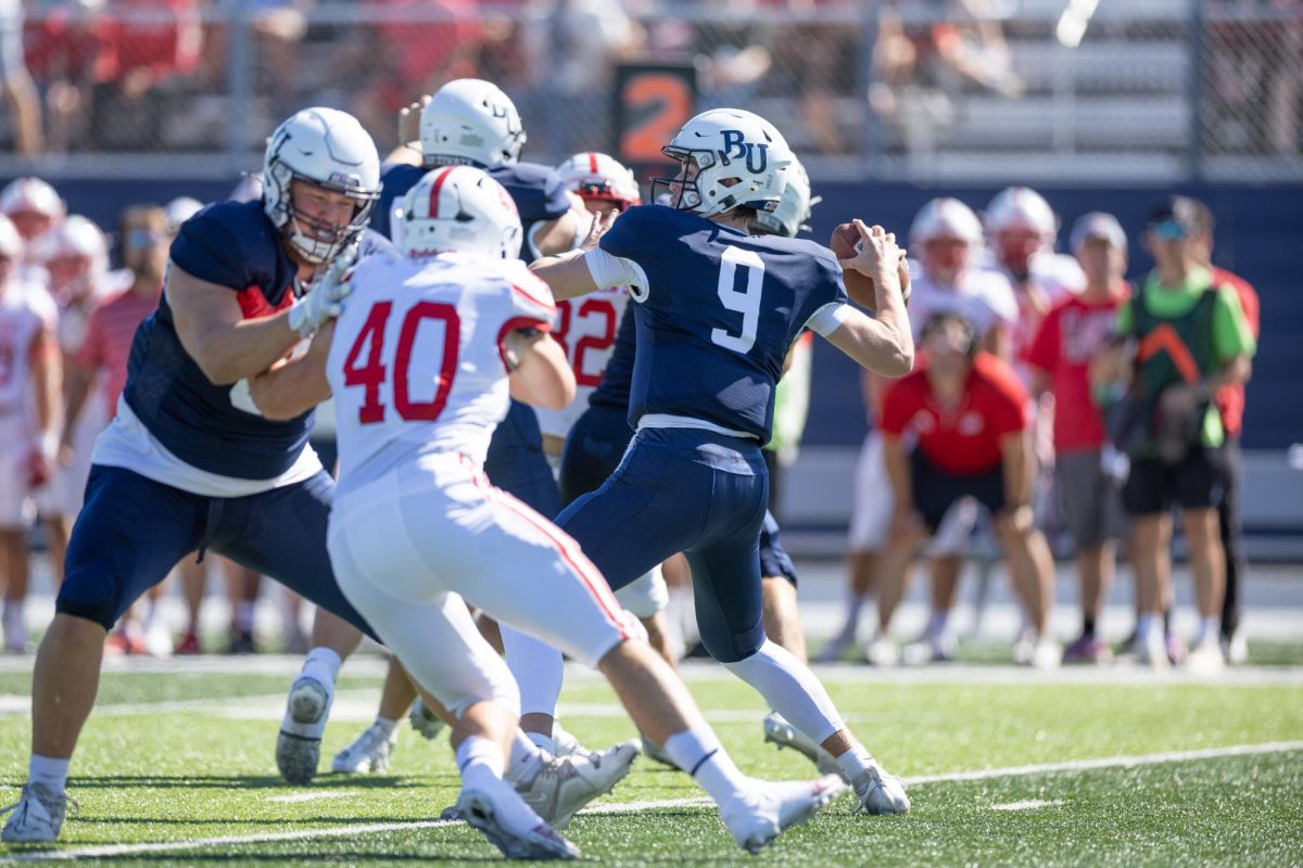 Sophomore quarterback Cooper Drews leans back to unleash a deep pass to Matt Jung down the left sideline. The pass went for a 69-yard touchdown on Bethel’s second offensive play of the game. | Photo by Nathan Klok, Bethel Athletics.