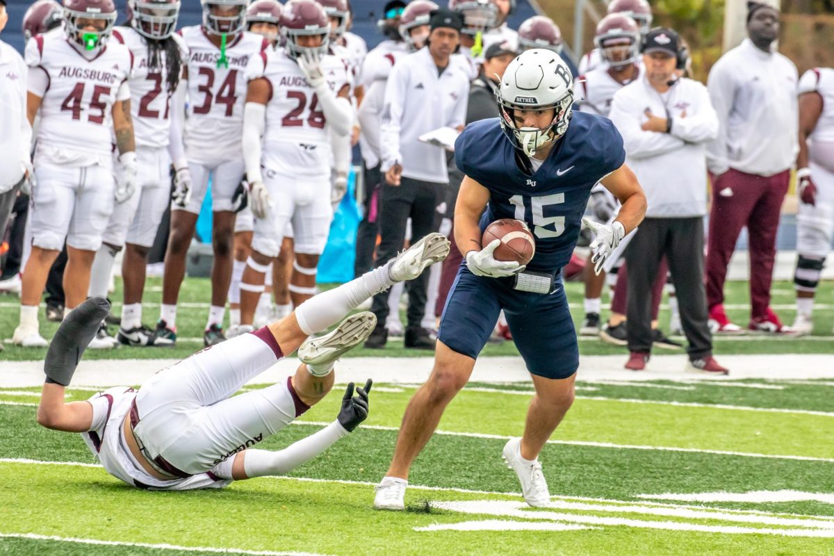 Senior Bethel receiver Micah Niewald sheds a would-be tackler on his way to a touchdown in the Royals’ 73-8 win over Augsburg Saturday. Niewald sped his way to two touchdowns in the win, tallying 62 yards after the catch between the two scores. “Knowing I can outrun the guy that’s chasing me is a big thing,” Niewald said. “That’s going back to [strength and conditioning] Coach Meyer and everything we do in the summer and off-season.” | Photo by Carl Schumland, Bethel Athletics