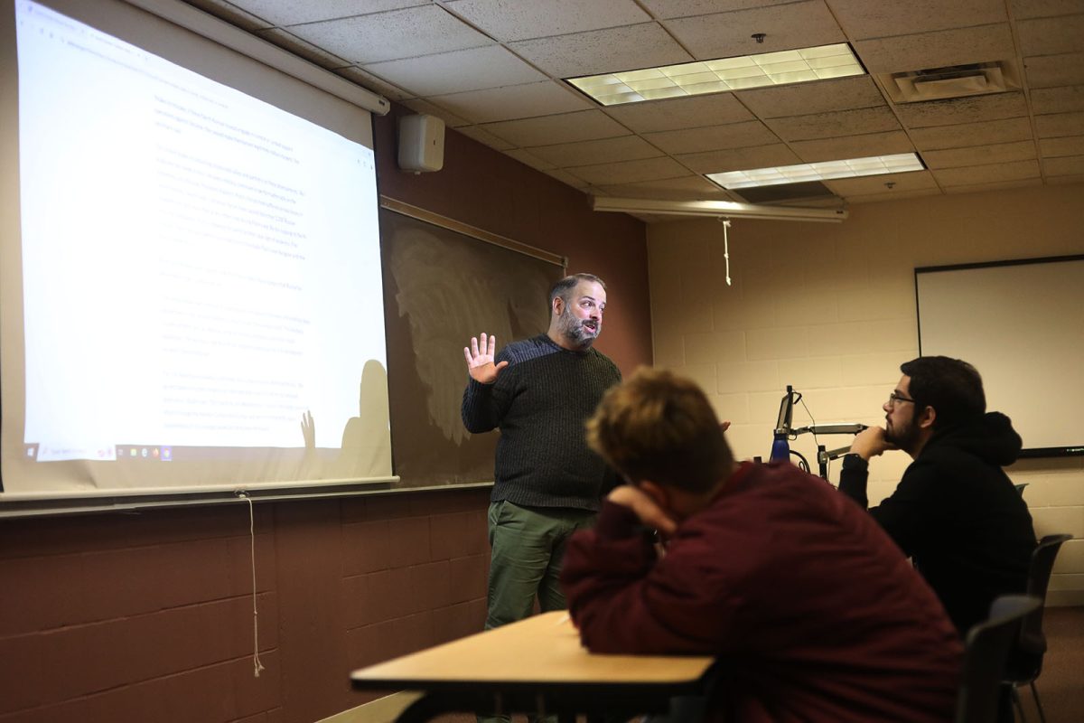 Chris Moore stands in front of his students during his Foreign Relations class Friday Nov. 1. As Election Day approaches, Moore and his co-host Andy Bramsen want students to be equipped to have political conversations with those around them. "We created the podcast with the goal of modeling talking about politics civilly and not so divisively," Bramsen said. 