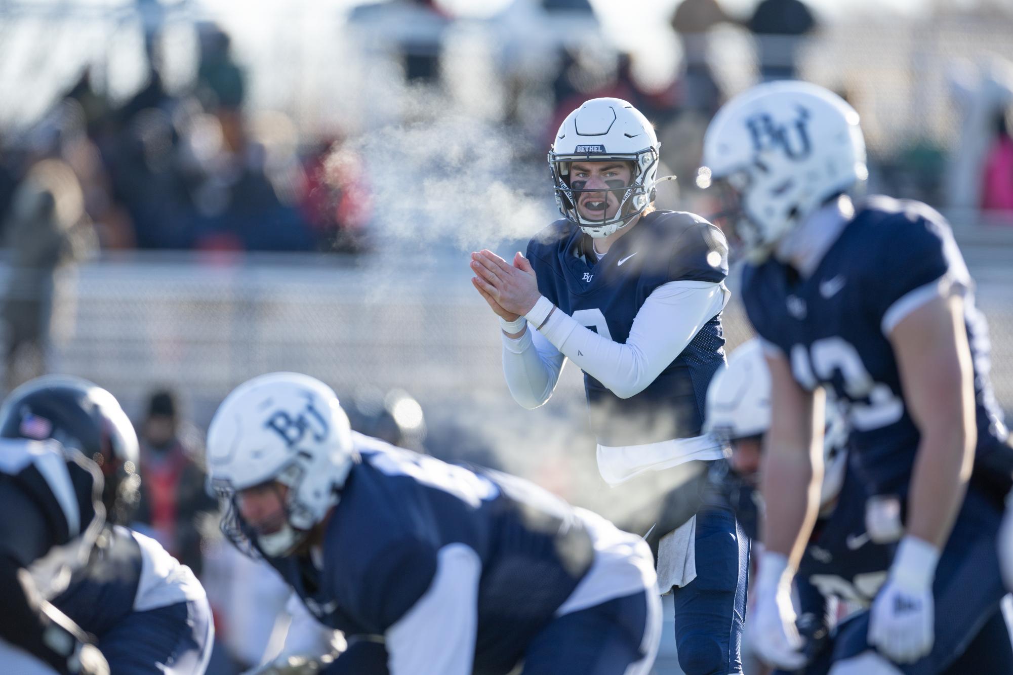 Bethel University quarterback Cooper Drews’ breath is visible as he calls for the snap during the Royals 48-21 win over Lake Forest College Saturday. The Royals and the Foresters battled through the late November chill with a game time high of 19 degrees during the second round NCAA playoff matchup at Royal Stadium. “The cold weather was kind of another challenge,” Drews said. “We talked about we’re not going to let that affect us, but obviously you stand out there for the whole game you’re going to feel it.”