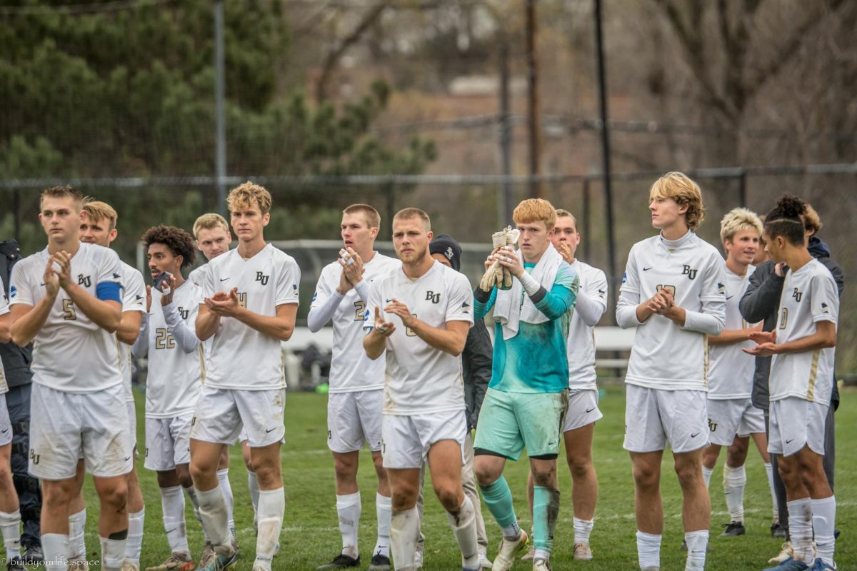 The Bethel men's soccer team applauds the many fans that showed up for the 2 p.m. kickoff Monday. Bethel lost its first ever home playoff game 5-2 versus the Carleton College Knights. | Photo by Teresa Brubaker, Bethel Athletics