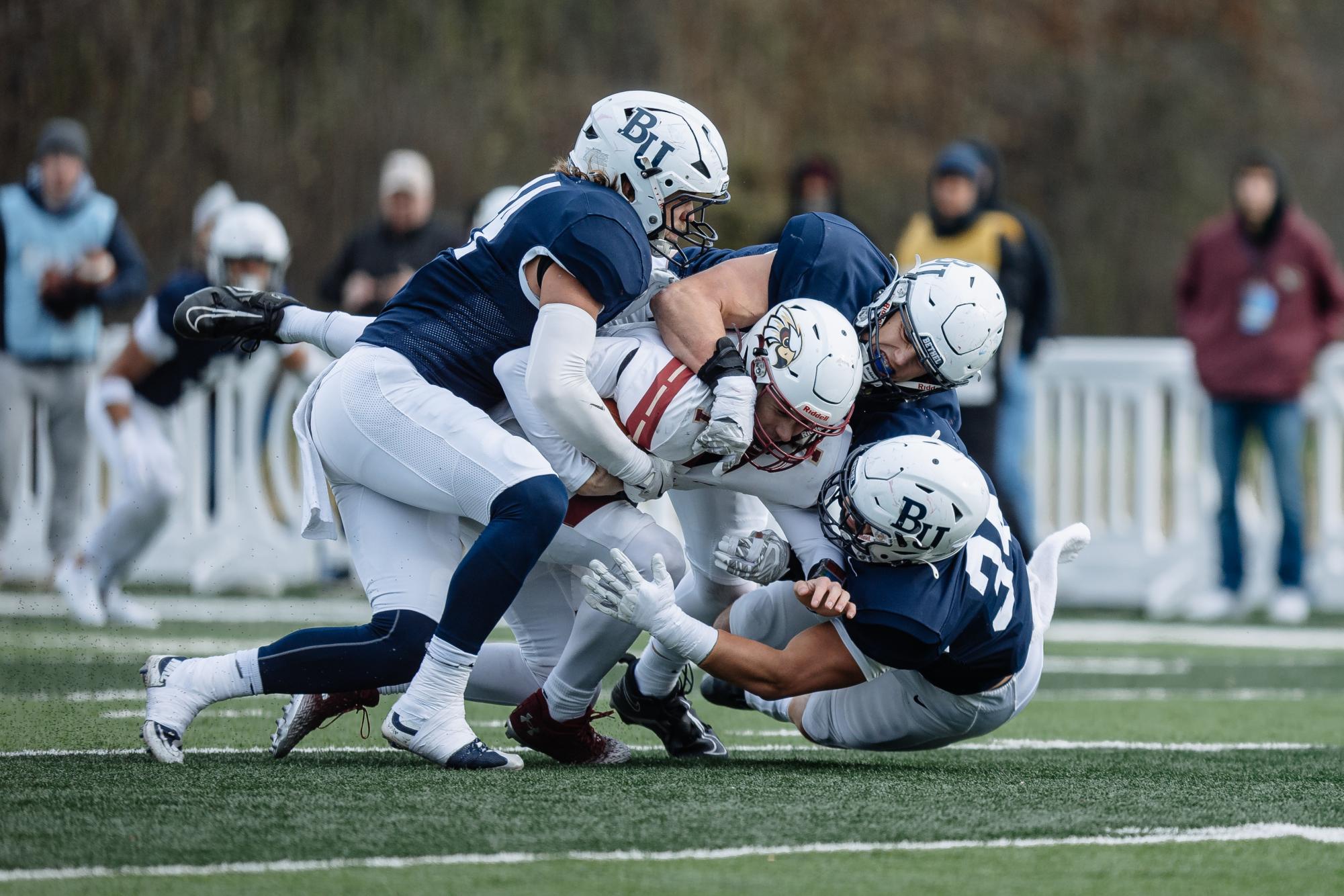 Royals defenders Jacob Holmen, Caden DeWall and Kolin Baier swarm Coe College quarterback Brady Kelly for a sack during Bethel’s 31-26 NCAA playoff victory Saturday. The trio combined for eight of Bethel’s ten sacks during the game, holding Coe to 22 total rushing yards. “That was fun,” Bethel head coach and defensive play caller Mike McElroy said. “Those guys have kind of been the anchor all year for us.” 