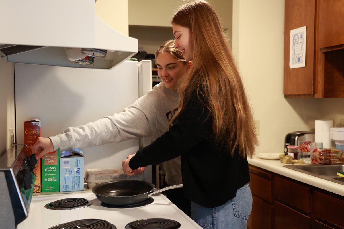 Sophie Jacques and Sophia Najarian laugh as they make eggs for breakfast in their newly renovated Turnwall dorm. The two roommates had lived in Heritage Hall for two months, where they weren’t able to cook like they had originally planned. 