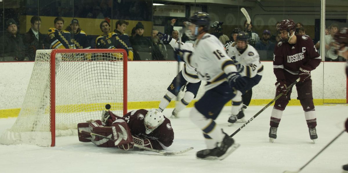  Bethel University junior defenseman Spencer Kring fires the puck past Auggie goaltender Carsen Stokes with 46.1 seconds to play in overtime during the Royals 4-3 win over Augsburg on Friday night. Kring is currently second on the team in points with 13 on the year, with five goals and eight assists.  