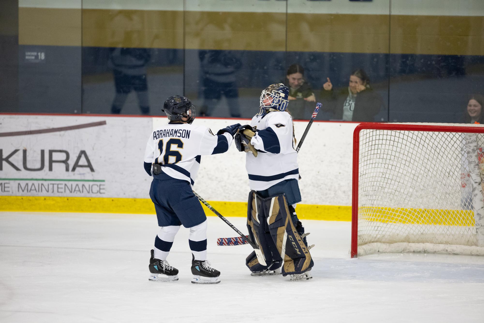 Bethel University goaltender Anna Hanson and forward Kallie Abrahamson bump fists after a 4-0 Royals win over Nichols College Friday night at Bethel University Arena. Abrahamson tallied her team-leading fifth and sixth goals of the season during Friday’s contest and Hanson earned her third shutout of the season stopping 18 Bison shots.  | Photo by Bethel Athletics 
