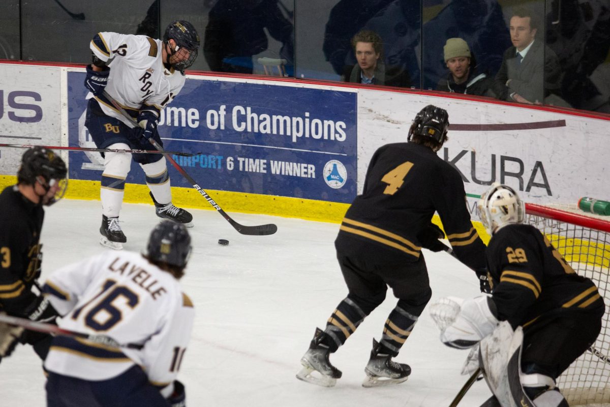 Senior forward Braeden Bartoo handles the puck in the offensive corner as linemate Shane Lavelle sits in the slot during the Royals’ 3-1 win against the Oles on Friday night at the National Sports Center. Their line had a number of scoring chances in the game. | Photo by Amy Holmberg