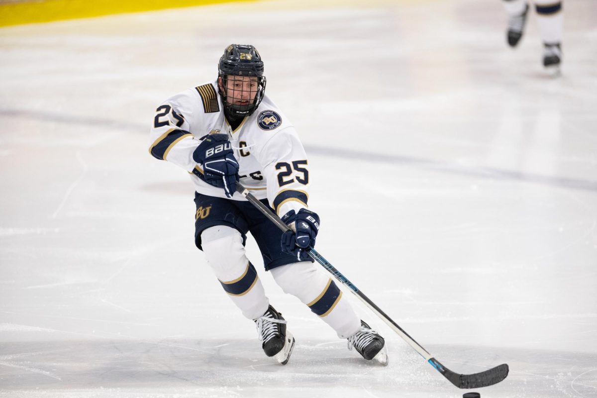 Bethel University junior center Jack Brown passes the puck up ice during the Royals 6-2 win over Concordia College Saturday night at the National Sports Center in Blaine. Brown is currently second on the team in points with 19, with 8 goals and 11 assists in 23 games this season. | Photo by Nathan Klok