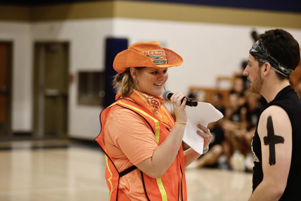 Cheer night emcees Noelle Jacobsen and Dylan Highum introduce the next competitors Oct. 13, 2025, in the Robertson Center gym at Bethel University.