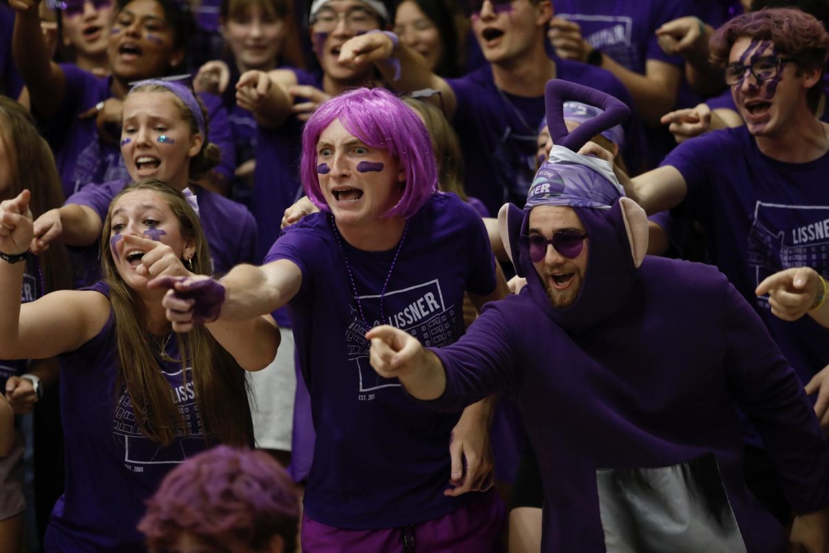 Lissner Hall residents Sam Clapp, right, and Michael Schultz yell and point during their cheer Oct. 13, 2025 ,in the Robertson Center gym at Bethel University.