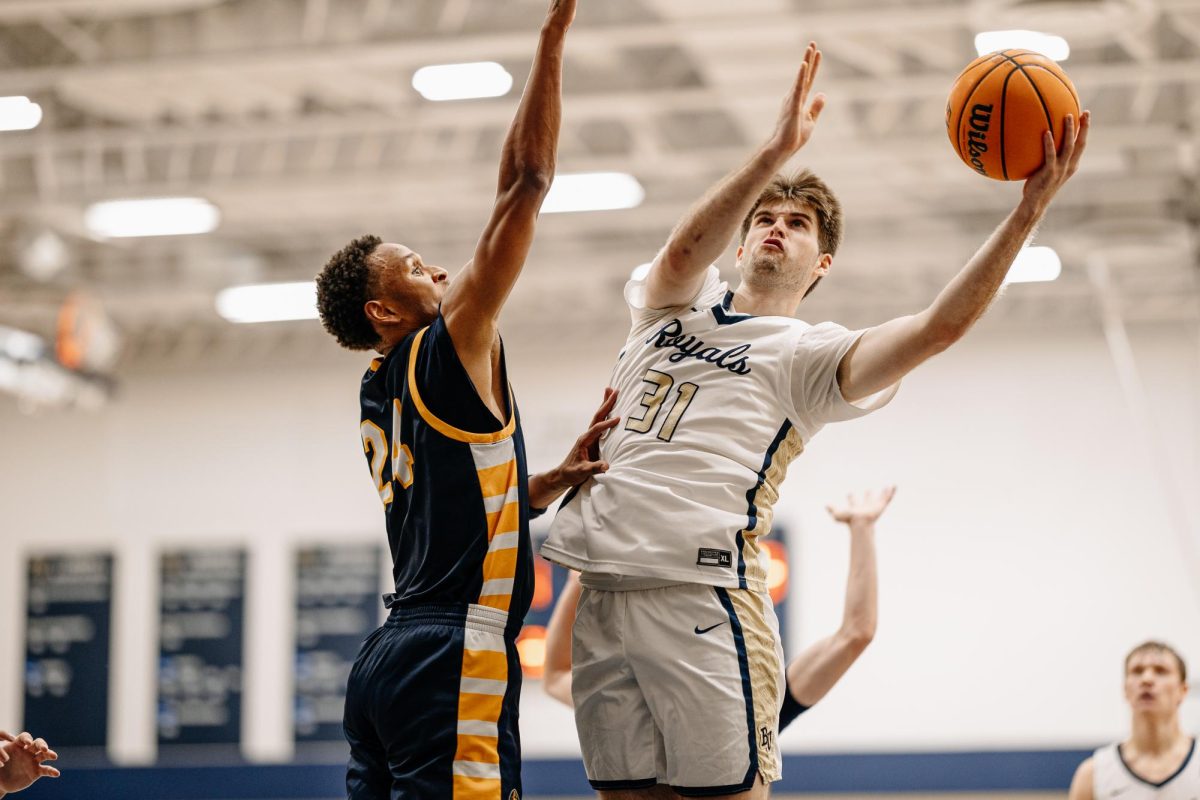 Redshirt junior Nick Burke puts up a layup during Bethel's 87-53 loss in its home opener against Augustana (IL). Burke scored 13 points in the game. 