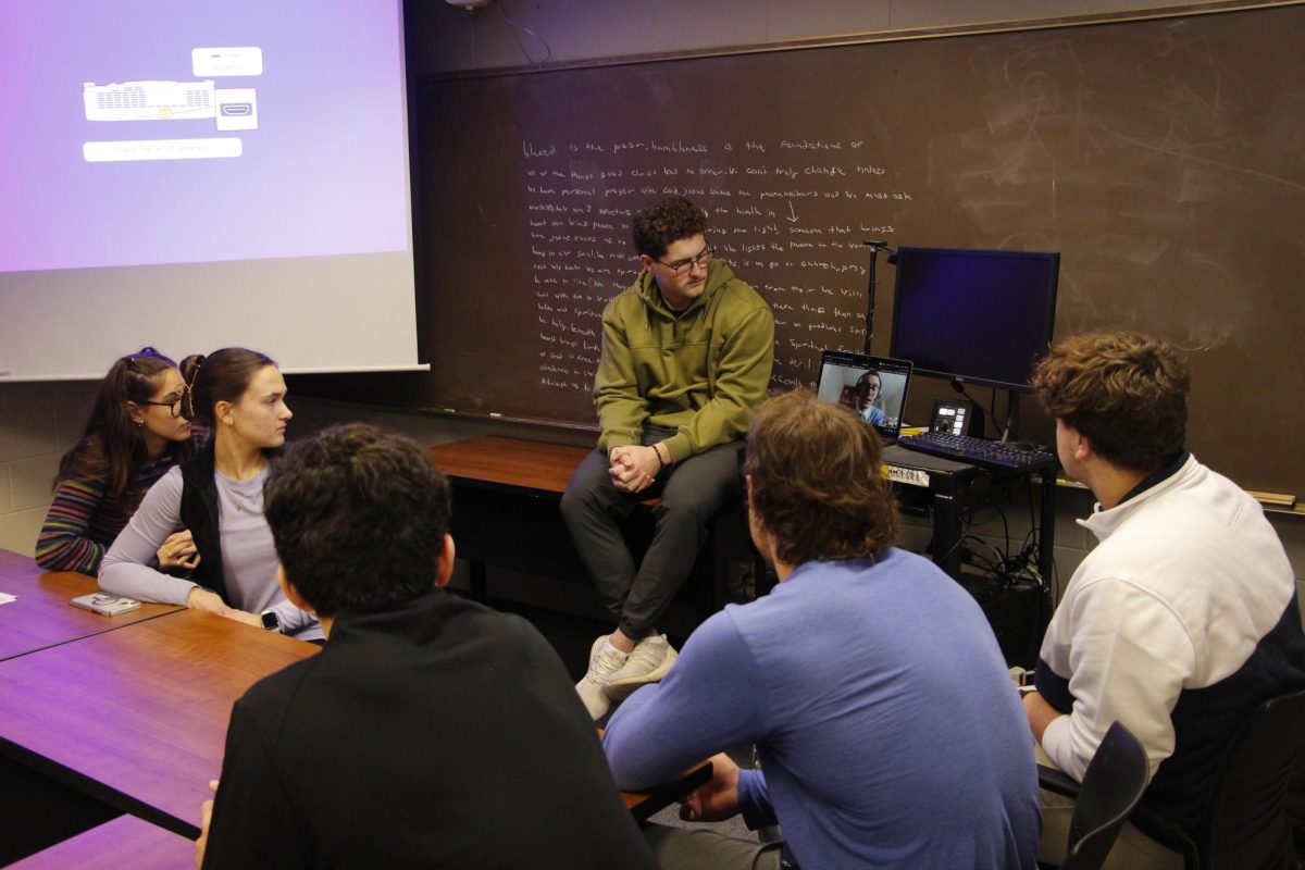 Catholic Student Association members speak to former Bethel student David Oolman at their meeting Nov. 21, 2025. Oolman spoke on a video call about his experience at Catholic seminary, which he currently attends. 
