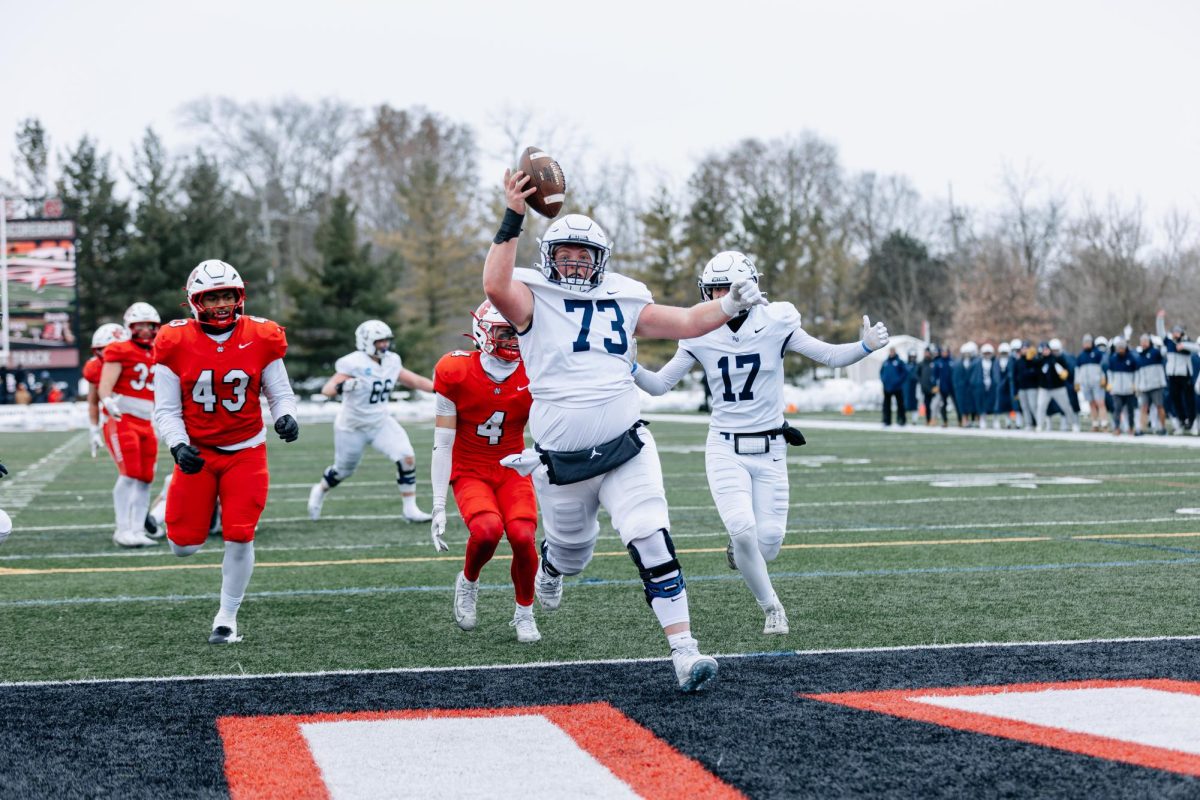 Center Jaegar Ash flaunts the football as he scores what seemed like an unlikely touchdown Saturday during Bethel's 35-21 playoff loss. Ash's score would not stand after official review deemed the play dead before Ash took the ball. 