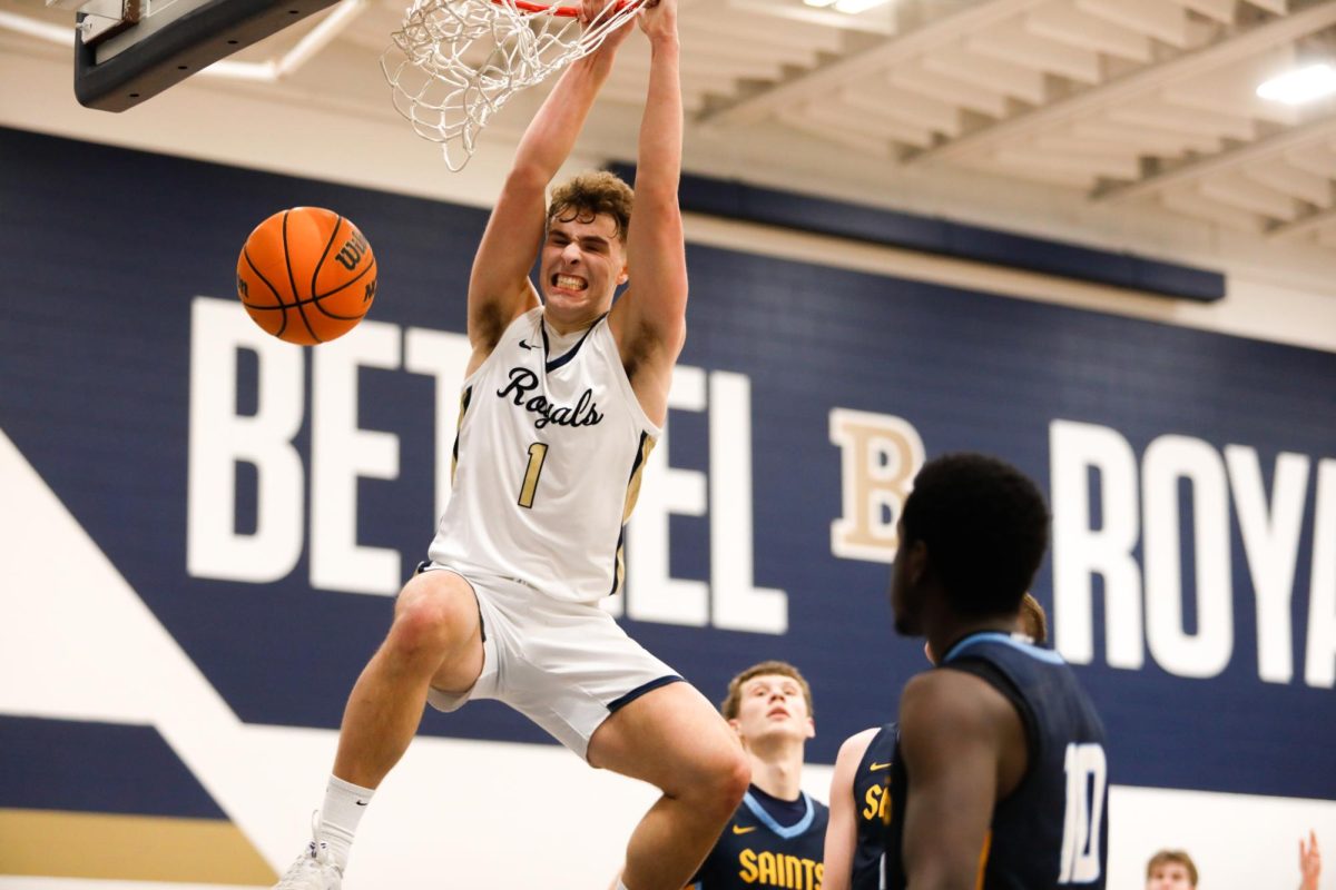Junior Bethel guard Sam Gingras slams home a dunk over three St. Scholastica defenders during the Royals’ 85-70 win Saturday. Gingras tallied 19 points, six assists and four rebounds in the game.