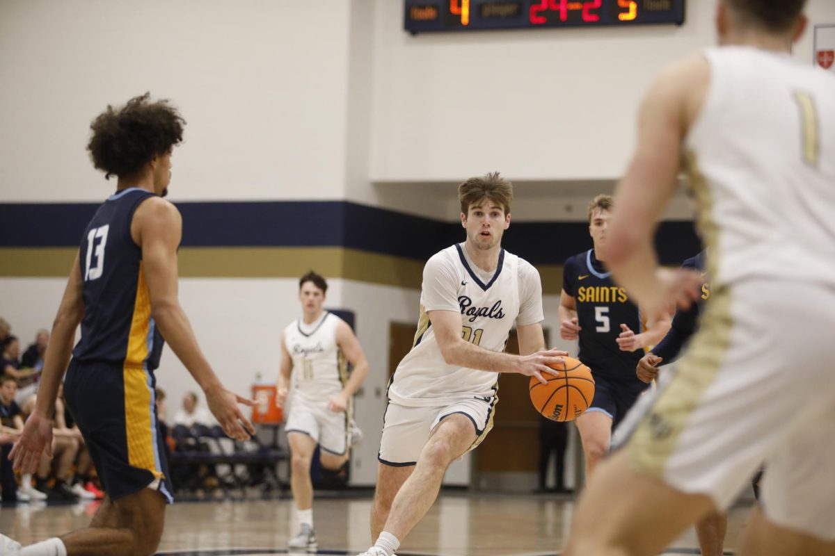 Bethel guard Nick Burke dishes the ball to guard Sam Gingras on a fast break. Burke added 16 points and six assists in the Royals' win. 