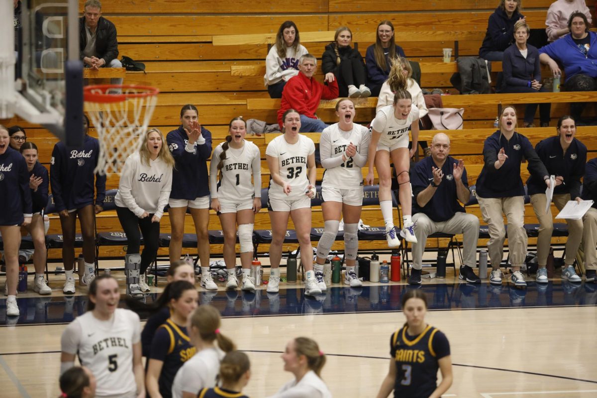 The Bethel University Royals' bench celebrates following an and-one call late during the team's 77-71 victory over the College of Saint Scholastica. 