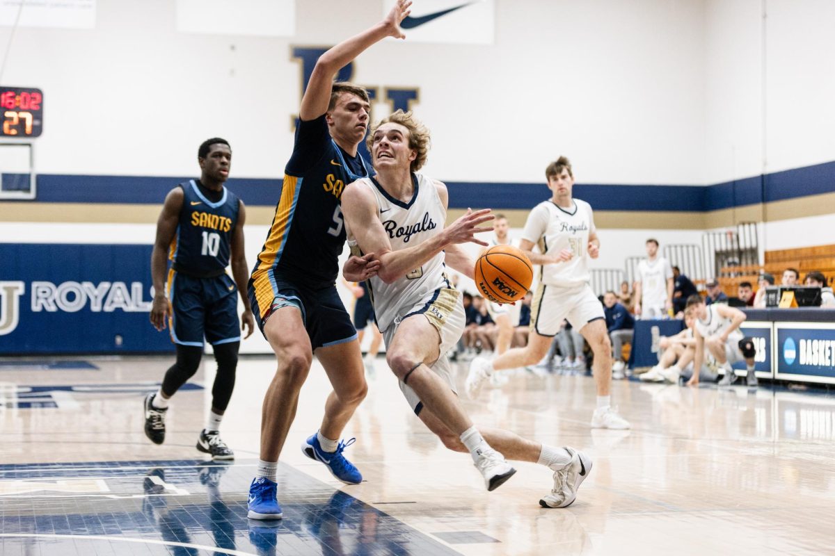 Bethel guard Blake Schmitz drives to the basket while being pressed by St. Scholastica defender, Hayden Kloos, left, at the Robertson Center in Arden Hills Feb. 7, 2026. Schmitz finished with 26 points and 7 total rebounds in the 85-70 Bethel win. 
