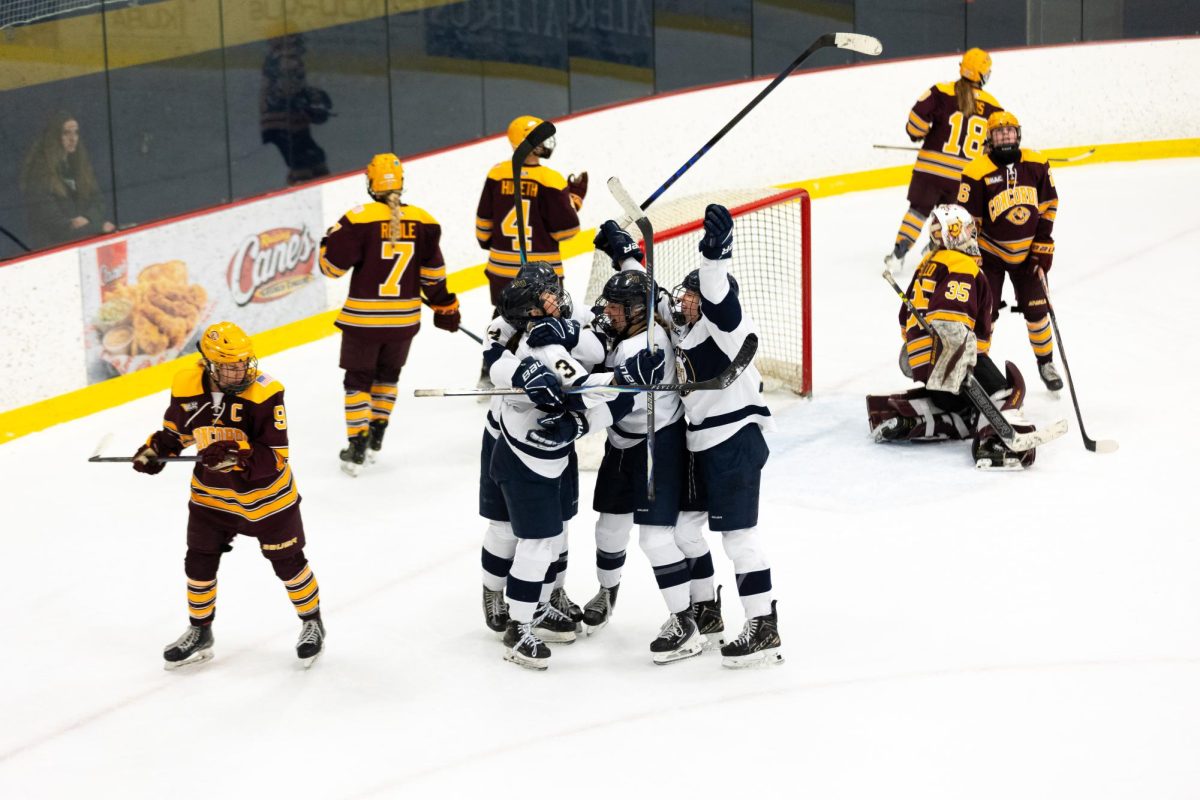Rylen Kissell's (Number 3) teammates mob her following her game-tying goal late in the third period of Friday's 2-1 overtime win over Concordia College. With the win and another Saturday, the Royals placed themselves in fifth-place in the MIAC, clinging to a playoff spot with two games to go. 