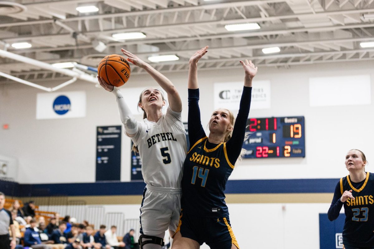 Senior Bethel forward Elly Schmitz goes up for a layup against St. Scholastica defender Kloey Lind at the Robertson Center in Arden Hills Feb. 7, 2026. 