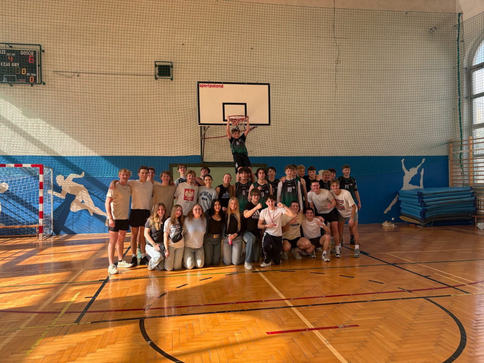 Bethel's 2026 Poland mission trip team members and the Zespół Szkół nr 8 im. Stanisława Staszica basketball team pose for a group photo after playing a game of basketball in the school’s gymnasium. | Photo submitted by Jillian Nelson
