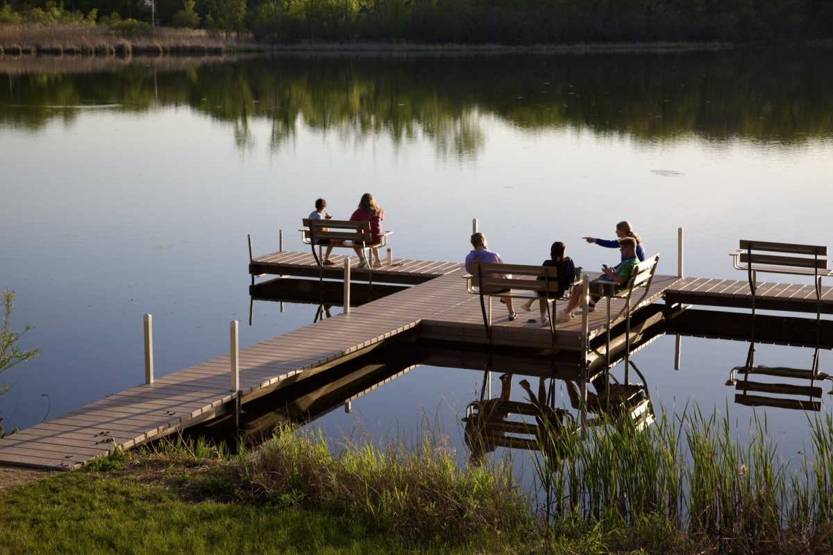 Bethel University students sit on the dock over Lake Valentine May 11, 2024.