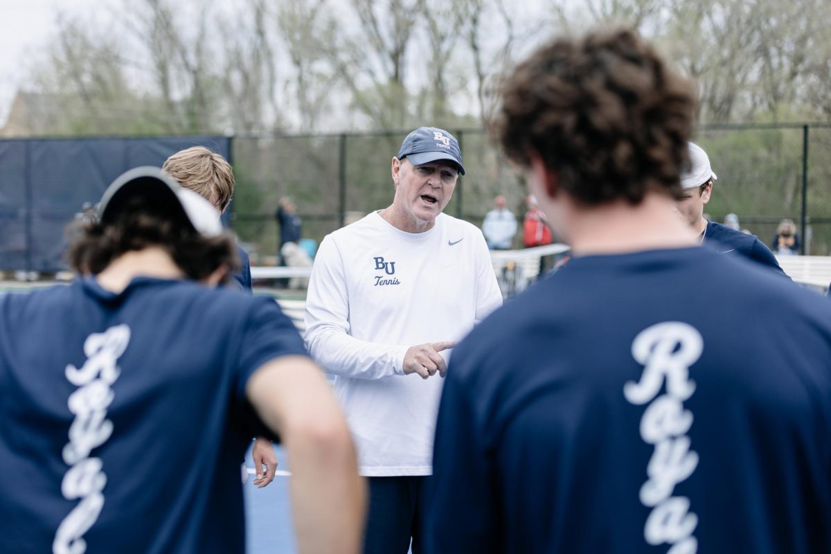 Bethel University tennis head coach Drew Fernelius addresses the men’s team ahead of its April 25 match against St. John’s University. Fernelius has coached the Royals’ men’s and women’s teams for 14 years, and holds a career winning record for both. “Success drives culture positivity,” Fernelius said. “But love for each other makes it go to a different level.” 